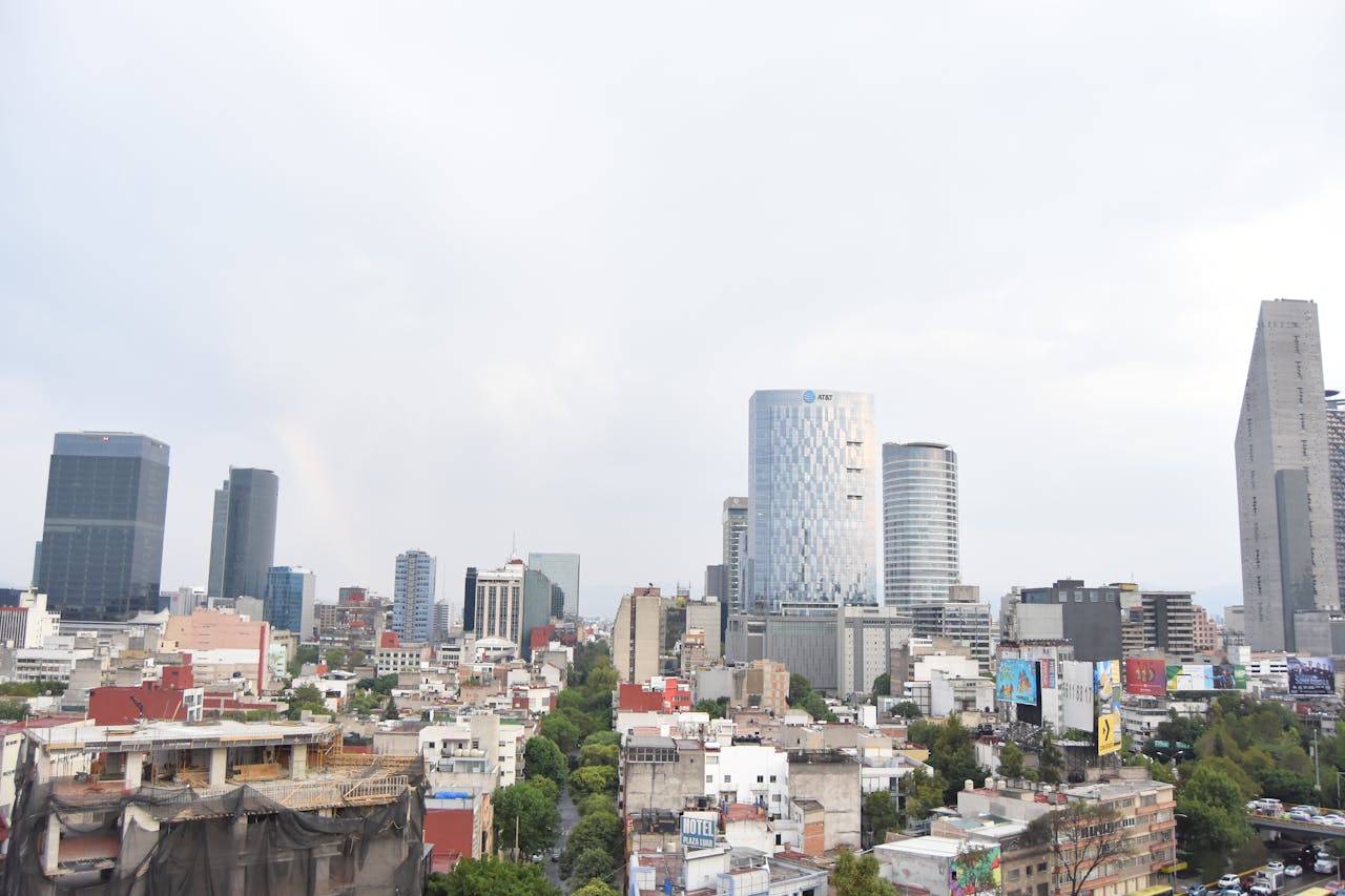 Aerial view of Mexico City's modern skyline with tall skyscrapers and urban landscape.